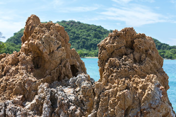 rocks in the sea on the island background in sunny weather