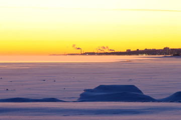 Frozen lake and northern city in the background. Petrozavodsk, Russia