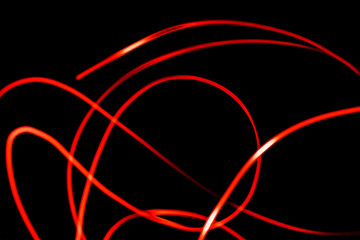Abstract futuristic red neon background created by light motion