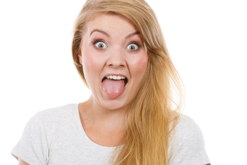 Funny blonde woman sitcking tongue out