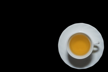 Jasmine tea cup in black background with left copyspace