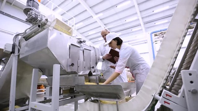Checking the product quality on the macaroni factory