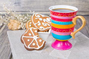 Coffee with homemade gingerbread on the grey wooden table