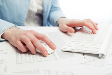Business woman using computer mouse and keyboard