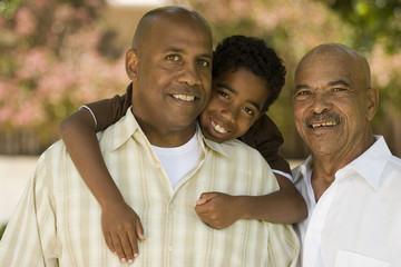 Grandfather with his adult son and grandchild.