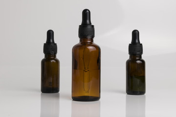 isolated drop glass bottle in brown color.