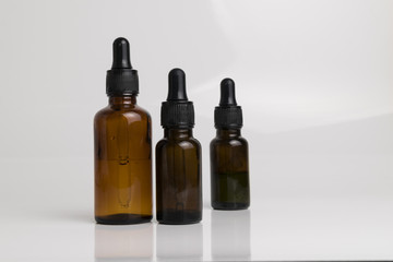 isolated drop glass bottle in brown color.