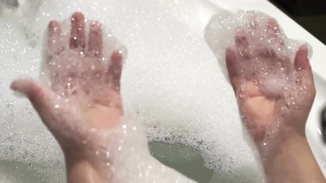 Feet enjoying a relaxing bathtub in bubble bath