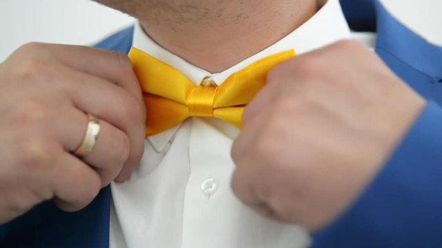 man straightens his tie