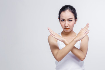 Beautiful Asian woman made the gesture reject isolated on white