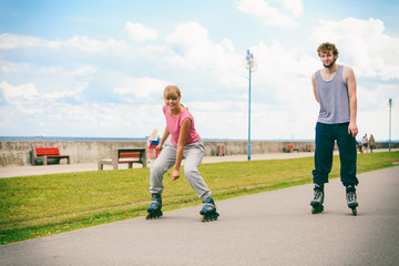 Fototapeta premium Two people race together riding rollerblades.