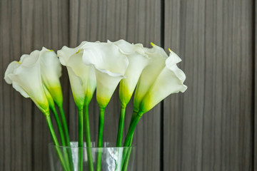 Fresh white lilies in a glass vase.
