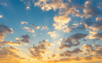 Dramatic sky background include sunset or sunrise, abstract cloud look fluffy. Represent weather, wind, heaven, freedom and god. Colorful with yellow, orange and blue color at evening in autumn. 