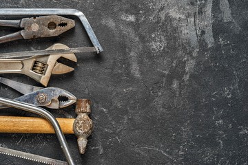 Set of tools on dark cement background with copy space. Suitable as fathers day card.