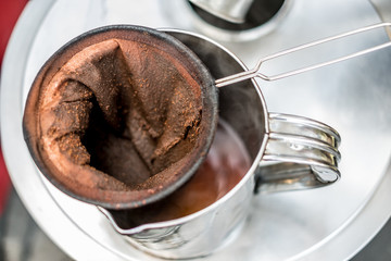 make old coffee bag , pot With tool . Street food and drink Thailand .