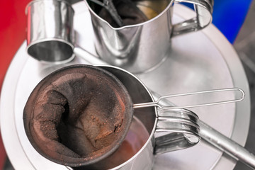 make old coffee bag , pot With tool . Street food and drink Thailand .