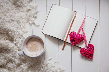 Note with two red hearts and cup of coffee cozy white plaid, atmosphere, for text, background