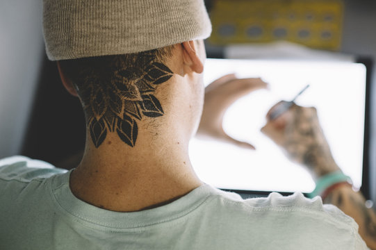 Tattoo master working with sketch