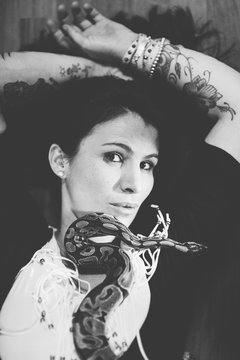 Woman with snake clasping her hand