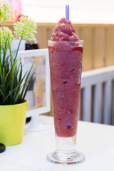 mixberry smoothie with strawberries in pots on a wooden table