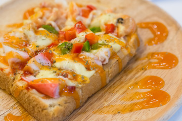 Seafood pizza in wood dish
