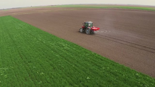 Fertilizer spreading on the field.Aerial footage.