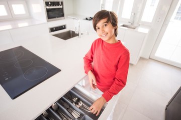 A boy standing in new modern kitchen