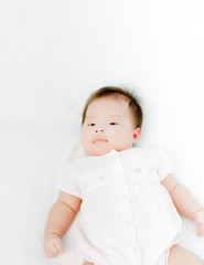 Portrait of adorable baby girl. Isolated on white background wit