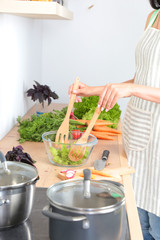 Fresh vegetables on the cutting board are falling in the pot, concept of cooking