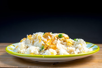 Homemade Chinese fried rice with vegetables and fried eggs