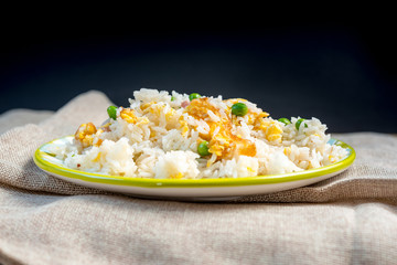 Homemade Chinese fried rice with vegetables and fried eggs