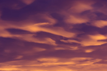 Colorful clouds of various shades on sunrise sky