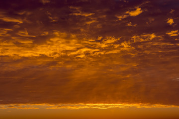 Sunrise sky covered with colorful clouds in various shades