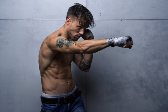 Muscular fighter doing shadow fight