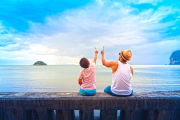 Father and son eat ice cream Or Family Asian holding ice cream on the beach