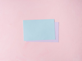 Green Pastel color card on pink textured background. Baby birthday party invitation or valentine. Copy space