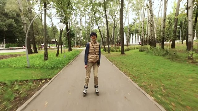 Roller skates. Female roller-skater practicing inline skating in the autumn park. 4K