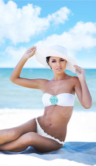 Beautiful girl in a bikini posing on the beach