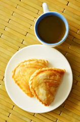 curry puff stuffed chicken and bean eat couple with hot tea
