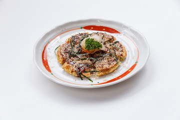 Okonomiyaki is a Japanese savoury pancake containing a variety of ingredients.