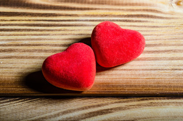 Happy Valentine's Day. Two red hearts on wooden background. Love