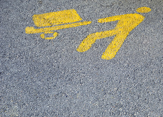 Yellow parking symbol for loading and unloading goods area on the ground, with copy space.