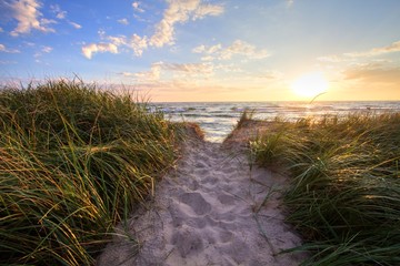 Path To A Summer Sunset Beach. Sandy beach trail leads to a sunny summer horizon over the open waters of Lake Michigan. Hoffmaster State Park. Muskegon, Michigan. - obrazy, fototapety, plakaty