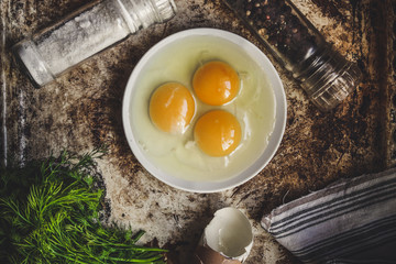 three broken eggs in a plate




