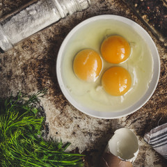 three broken eggs in a plate



