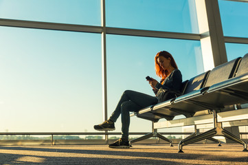 Young girl at the station waiting hall.