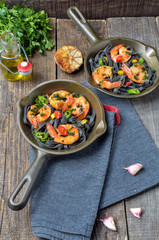 whole grain spaghetti pasta with shrimps and broccoli, top view,