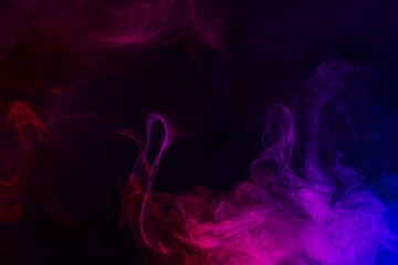 Abstract smoke Weipa. Personal vaporizers fragrant steam. The concept of alternative non-nicotine smoking. Purple pink smoke on a black background. E-cigarette. Evaporator. Taking Close-up. Vaping.
