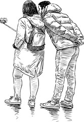 young people photographing themselves on the mobile phone