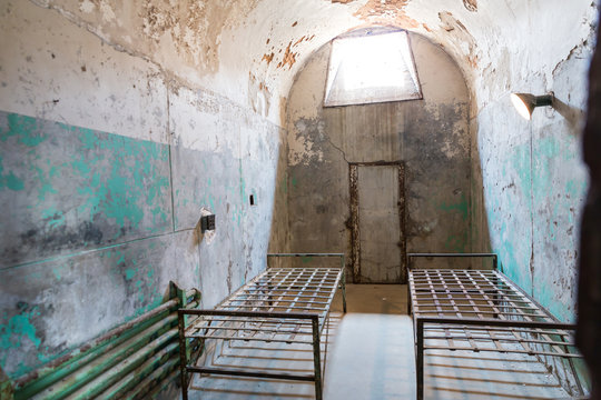 Grunge prison cell with sunlight window